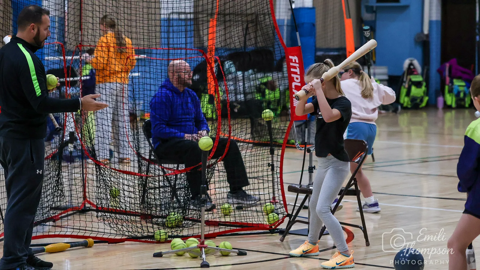 A training session in progress with hitting nets and stations set up